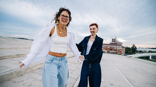Friends laughing together on an urban rooftop walk