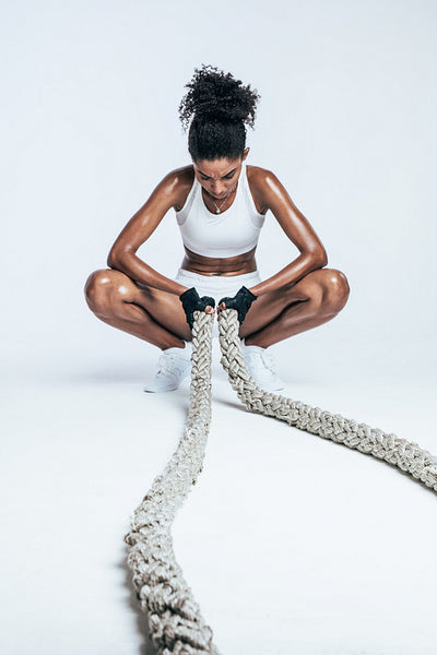 Exhausted woman resting after cross training