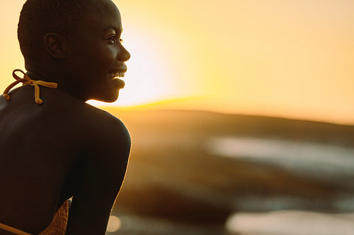 Smiling african woman on the beach at sunset