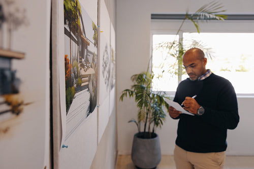 Male professional planning a building project at an office space