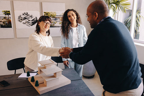 Professionals shaking hands during a successful planning meeting with a client