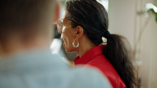 Focused woman explains an idea during a team meeting in a cafe office