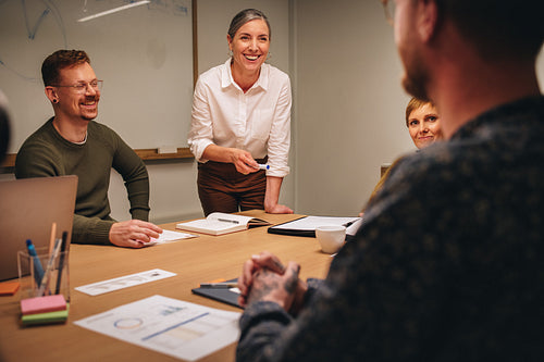 Manager explaining project to colleagues in meeting
