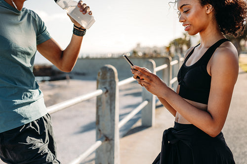 Fitness couple taking a break after workout