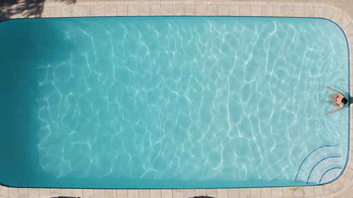 Woman swimming in the resort pool