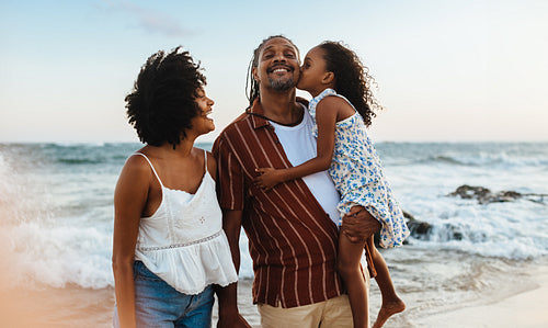 Happy Brazilian family enjoying a beach vacation together
