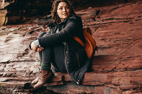 Female tourist relaxing on a mountain