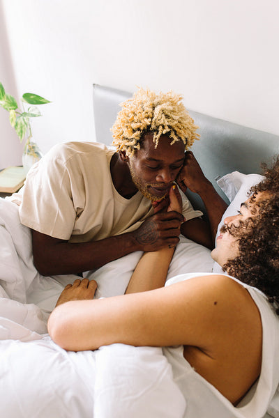 Cute gay couple being romantic in their bedroom