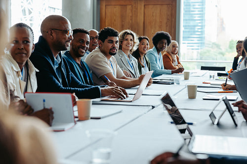 Diverse team in a business conference discussing corporate strategies in a modern office