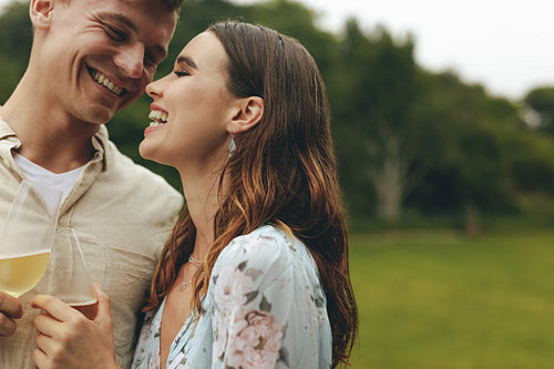 Affectionate couple with champagne at park