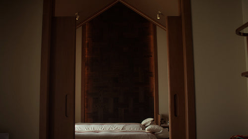 Spa therapist preparing luxury massage room in tranquil hotel spa setting