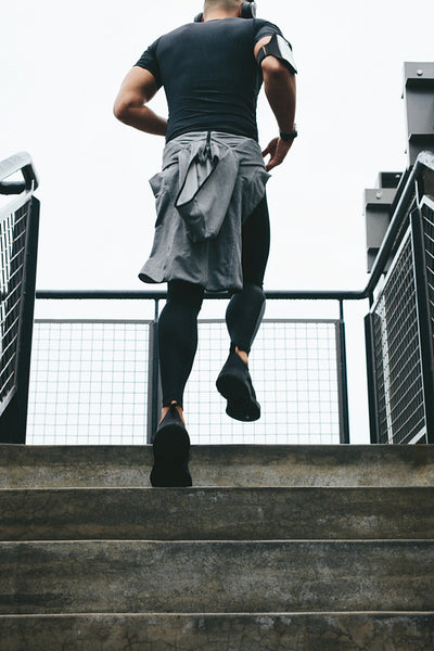 Fit young man running up stairs
