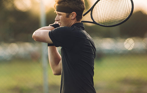 Tennis player practicing on a club court