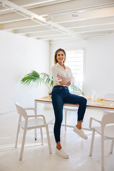 Cheerful businesswoman sitting in a boardroom before a meeting