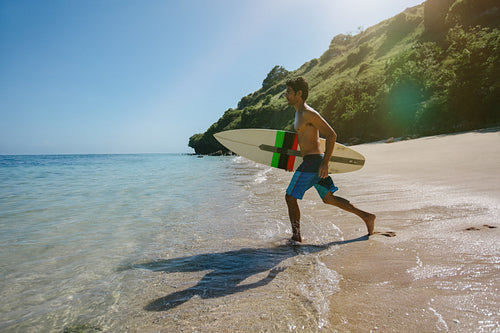 Young man going for water surfing in the sea