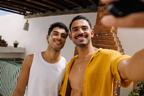 Two young men taking a selfie outdoors