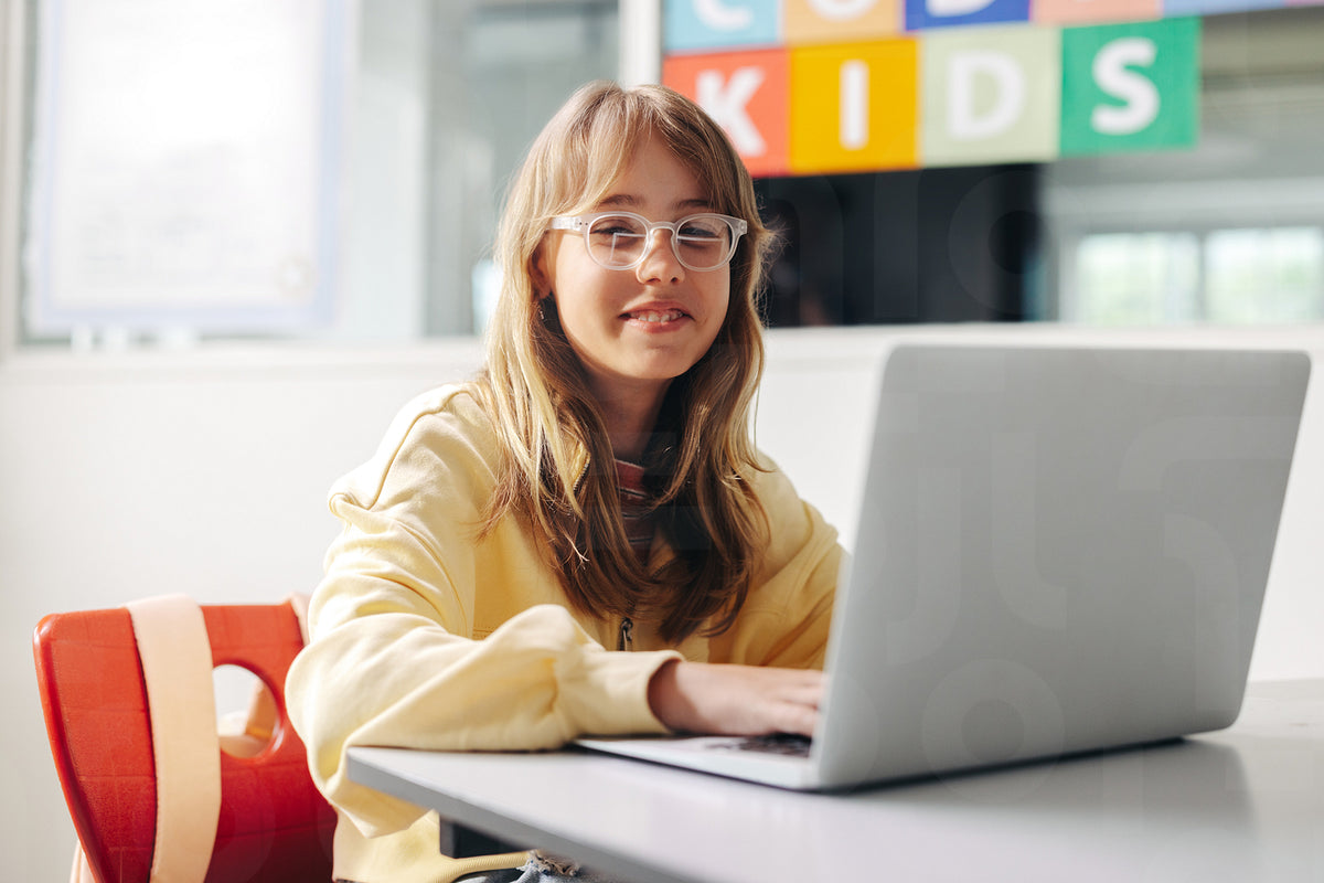 Young female student learning to programme in a computer science class ...