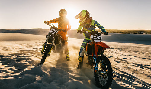 Motocross bike riders on desert track.