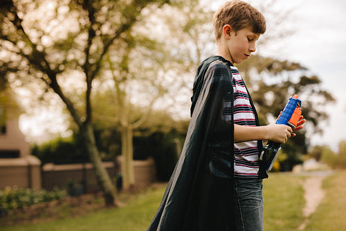 Boy with cape pretending to a superhero