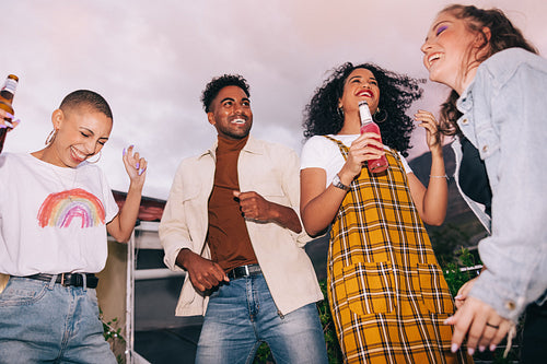 Friends dancing during a rooftop party
