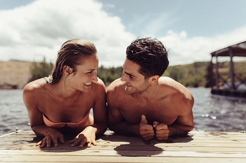 Couple on the wooden jetty at the lake