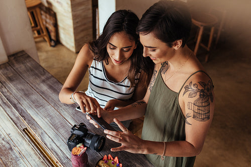 Woman food bloggers taking pictures of food stuff