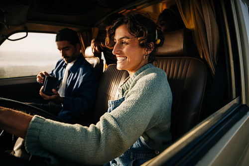 Friends on road trip smiling in a vintage van