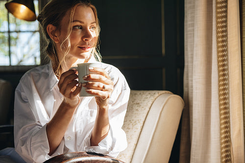 Woman looking outside her hotel window