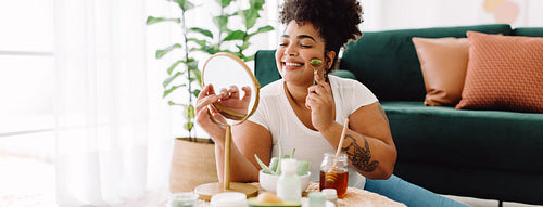Woman with beauty massage tools at home