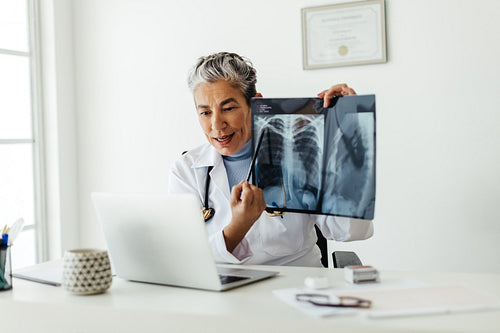 Radiologist explaining x ray results to a patient in a telemedicine visit