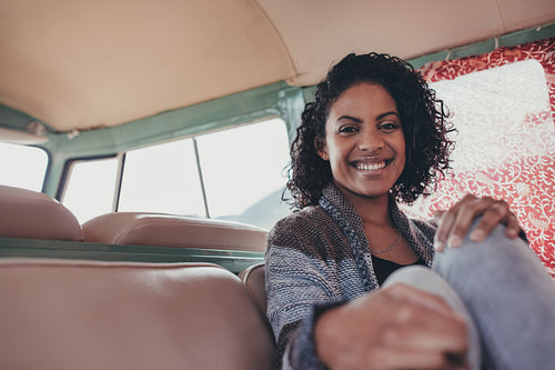 Woman on roadtrip travelling by a van