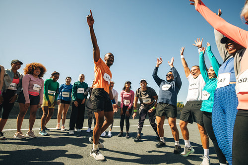 Team preparing for marathon under sunny blue sky