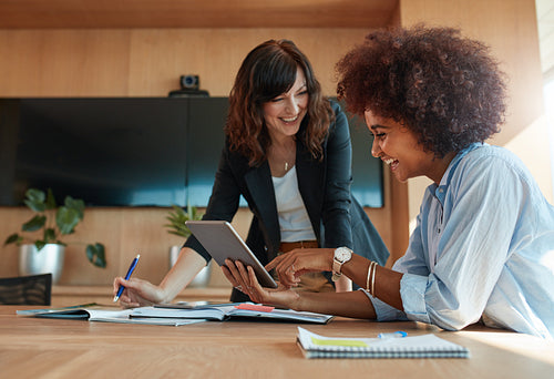 Creative female executives using digital tablet in office