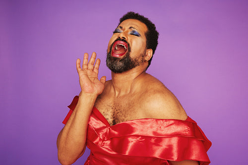 Drag queen singing in a theater