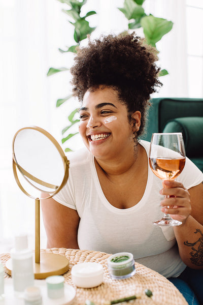Woman having wine during beauty care at home
