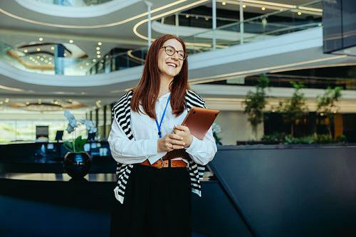 Successful professional woman in a large corporate office lobby