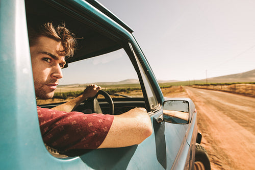 Man looking out of car while driving