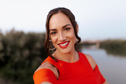 Young woman taking a selfie on a bridge