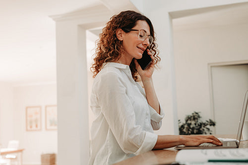 Businesswoman sitting at home and working