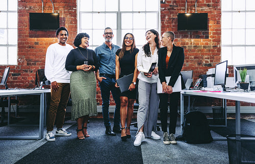 Happy group of businesspeople laughing in an office