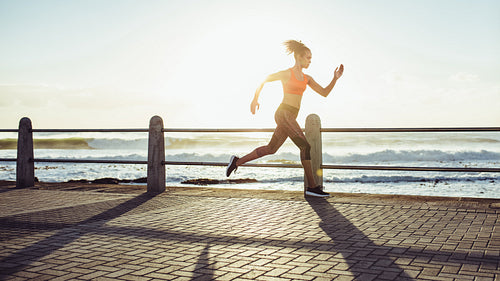 Woman sprinting during sunset
