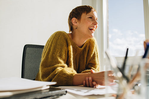 Female manager sitting at desk in office
