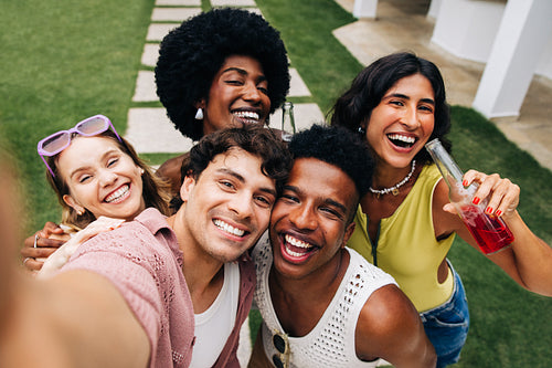 Friends taking a sunny outdoor selfie party