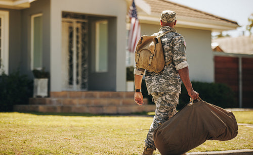 Rearview of a patriotic soldier returning home
