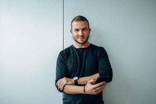 Confident young business professional with phone