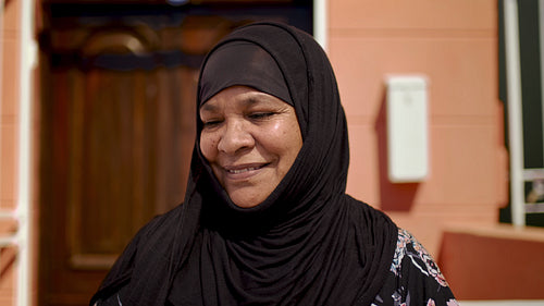 Happy Islamic woman in hijab outside