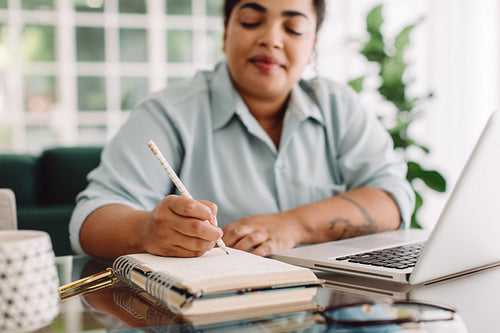 Woman working at home office desk