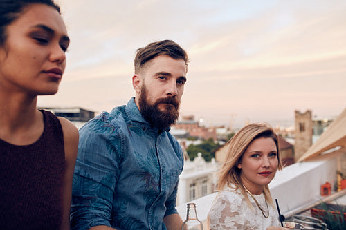 Young people together at a rooftop party