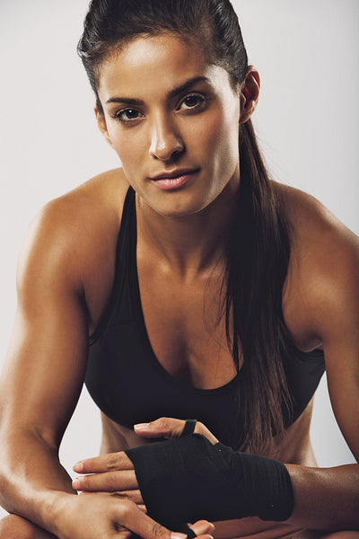 Female boxer preparing for fight 