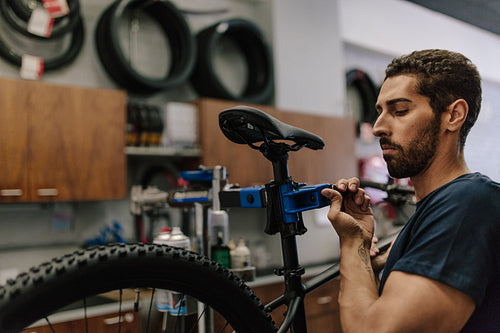 Mechanic repairing a bicycle in workshop